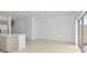 Open concept living area with kitchen island and access to the outdoor space at 34234 Polacca Ln, Wesley Chapel, FL 33543