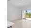 Open concept living space showing tile floors and access to the backyard at 34234 Polacca Ln, Wesley Chapel, FL 33543