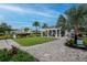 Enjoy a beautiful pool area with palm trees, outdoor seating, and a manicured lawn for relaxation and recreation at 34234 Polacca Ln, Wesley Chapel, FL 33543