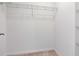 Bright walk-in closet with neutral carpet and a wire shelf for organized storage at 34234 Polacca Ln, Wesley Chapel, FL 33543