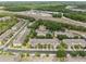 Aerial shot of townhomes with well-maintained landscaping, a nearby highway, and ample parking at 3901 Silverlake Way, Wesley Chapel, FL 33544
