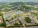 Expansive aerial view of a community with a large lake, lush green spaces, and neatly arranged residential areas at 3901 Silverlake Way, Wesley Chapel, FL 33544