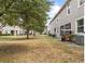 Home featuring well-maintained backyard with patio seating and mature trees at 3901 Silverlake Way, Wesley Chapel, FL 33544