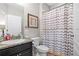 Bathroom with granite counters, dark cabinets, and a shower curtain at 3901 Silverlake Way, Wesley Chapel, FL 33544
