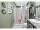 Bathroom featuring a glass shower door, granite countertop, and decorative wall art at 3901 Silverlake Way, Wesley Chapel, FL 33544