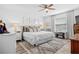 This white bedroom features a large window and plenty of pillows on the bed at 3901 Silverlake Way, Wesley Chapel, FL 33544