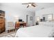 A well lit bedroom has a large bed with dresser and work desk at 3901 Silverlake Way, Wesley Chapel, FL 33544