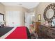 This bedroom features a closet, dresser, and a door to another room at 3901 Silverlake Way, Wesley Chapel, FL 33544