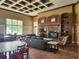 Lounge area with a fireplace, television, seating, tables and a book case at 3901 Silverlake Way, Wesley Chapel, FL 33544