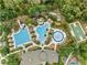 Aerial view of a community pool area with a water slide, lap pool, and lounge chairs at 3901 Silverlake Way, Wesley Chapel, FL 33544