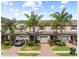 Inviting townhouse featuring well-maintained landscaping, a one-car garage and brick paved driveways at 3901 Silverlake Way, Wesley Chapel, FL 33544