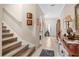 Inviting hallway features tile flooring and staircase to the second floor at 3901 Silverlake Way, Wesley Chapel, FL 33544