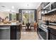 Open-concept kitchen provides modern appliances and view to adjacent living area at 3901 Silverlake Way, Wesley Chapel, FL 33544
