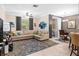 Comfortable living area featuring contemporary furnishings and access to kitchen area at 3901 Silverlake Way, Wesley Chapel, FL 33544