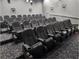 Movie theatre room with black leather recliners and a carpeted floor at 3901 Silverlake Way, Wesley Chapel, FL 33544