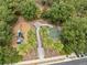 Aerial view of a neighborhood playground with slides, swings, and a basketball court surrounded by lush greenery at 3901 Silverlake Way, Wesley Chapel, FL 33544