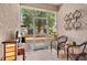Cozy screened in porch with wicker seating and decorative metal wall art at 3901 Silverlake Way, Wesley Chapel, FL 33544