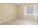 Neutral bedroom with tile floors, natural light and ample space at 39721 Meadowood Loop, Zephyrhills, FL 33542