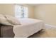 Cozy bedroom featuring tile floors, a large window, and a comfortable bed at 39721 Meadowood Loop, Zephyrhills, FL 33542