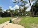 A dog enjoys the open space and walking path in the community's designated dog park area at 39721 Meadowood Loop, Zephyrhills, FL 33542