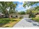 Single-story home with a manicured lawn and a concrete driveway leading to an attached one car garage at 39721 Meadowood Loop, Zephyrhills, FL 33542