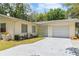 Charming single-story home with a manicured lawn, a one-car garage, and a concrete driveway at 39721 Meadowood Loop, Zephyrhills, FL 33542