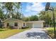 Charming single-story home with a well-maintained lawn, a one-car garage, and a long driveway at 39721 Meadowood Loop, Zephyrhills, FL 33542