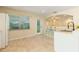 Kitchen area featuring tile flooring, shelving, and a stainless steel sink at 39721 Meadowood Loop, Zephyrhills, FL 33542