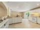 Bright kitchen with white appliances, tile flooring, and a view to the dining area at 39721 Meadowood Loop, Zephyrhills, FL 33542