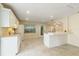 Bright kitchen featuring an arched entry, modern lighting, and ample counter space at 39721 Meadowood Loop, Zephyrhills, FL 33542