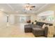 Spacious living room featuring tile floors, an open layout, recessed lighting, and a ceiling fan at 39721 Meadowood Loop, Zephyrhills, FL 33542
