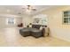 Expansive living room featuring tile flooring, an open layout, and a ceiling fan, filled with natural light at 39721 Meadowood Loop, Zephyrhills, FL 33542
