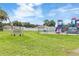 Exterior shot of the community playground featuring colorful playground equipment and manicured lawn at 39721 Meadowood Loop, Zephyrhills, FL 33542
