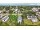 Aerial view of a cozy home with a fenced backyard, lush trees, and a well-maintained lawn at 4339 58 N Ave, St Petersburg, FL 33714