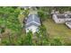 An aerial view of the charming residence with a backyard, deck, and mature trees around the property at 4339 58 N Ave, St Petersburg, FL 33714
