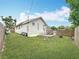 Expansive backyard featuring green lawn, wood fence and deck with table and chairs at 4339 58 N Ave, St Petersburg, FL 33714