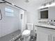 Bathroom featuring a tiled shower, granite countertop, and decorative tile flooring at 4339 58 N Ave, St Petersburg, FL 33714