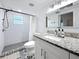 Beautiful bathroom featuring a tiled shower, granite countertop, and decorative tile flooring at 4339 58 N Ave, St Petersburg, FL 33714