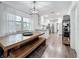 Modern kitchen and dining area with a large wooden table and an island with stainless steel appliances at 4339 58 N Ave, St Petersburg, FL 33714