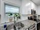 Bright kitchen with granite countertops, stainless appliances, and a window showcasing greenery at 4339 58 N Ave, St Petersburg, FL 33714