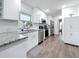 Modern kitchen with white cabinets, granite countertops, stainless steel appliances, and stylish flooring at 4339 58 N Ave, St Petersburg, FL 33714