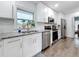 Well-lit kitchen featuring white cabinetry, stainless steel appliances, and a window view at 4339 58 N Ave, St Petersburg, FL 33714