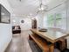 Bright living room featuring hardwood floors, a comfortable couch, and an elegant wooden dining table at 4339 58 N Ave, St Petersburg, FL 33714