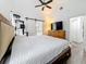 Cozy bedroom with hardwood floors, a dresser, and a glimpse into the ensuite bathroom at 4339 58 N Ave, St Petersburg, FL 33714