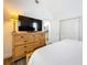 Comfortable bedroom featuring a wooden dresser with an adjacent kitchen view at 4339 58 N Ave, St Petersburg, FL 33714
