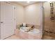 Elegant bathroom showcasing a soaking tub, a separate shower, and stylish tile work at 450 Knights Run Ave # 1003, Tampa, FL 33602