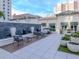 The outdoor common area features seating, decoratove stone fountain, and an open-air patio at 450 Knights Run Ave # 1003, Tampa, FL 33602
