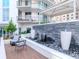 The outdoor common area features seating, decoratove stone fountain, and an open-air patio at 450 Knights Run Ave # 1003, Tampa, FL 33602