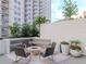 Tranquil courtyard with ample seating, a gas fire pit, vibrant flowers, and lush greenery at 450 Knights Run Ave # 1003, Tampa, FL 33602