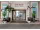 Welcoming building entrance with sliding doors and beautiful plants at 450 Knights Run Ave # 1003, Tampa, FL 33602